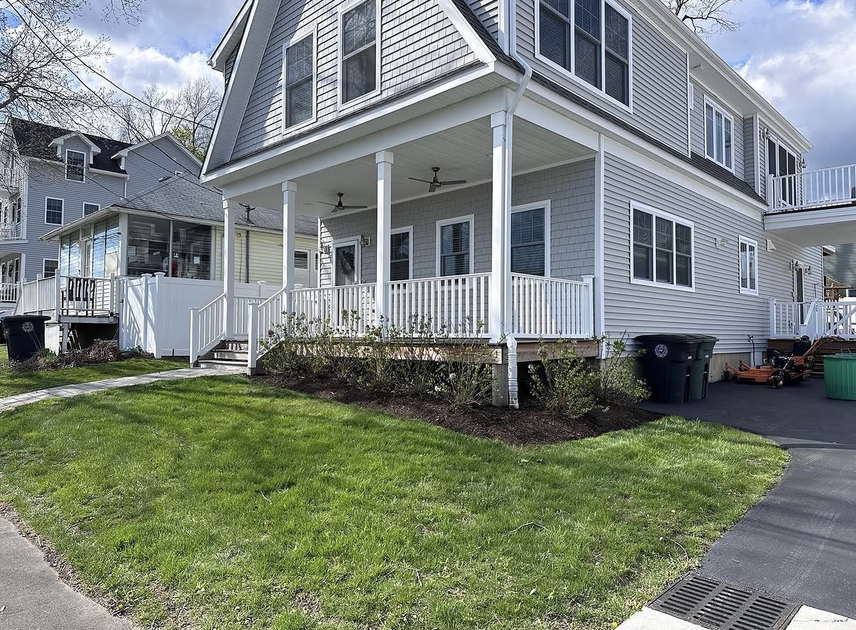 Lawn after Premier Property Maintenance service — fresh mulch and crisp mowing stripes