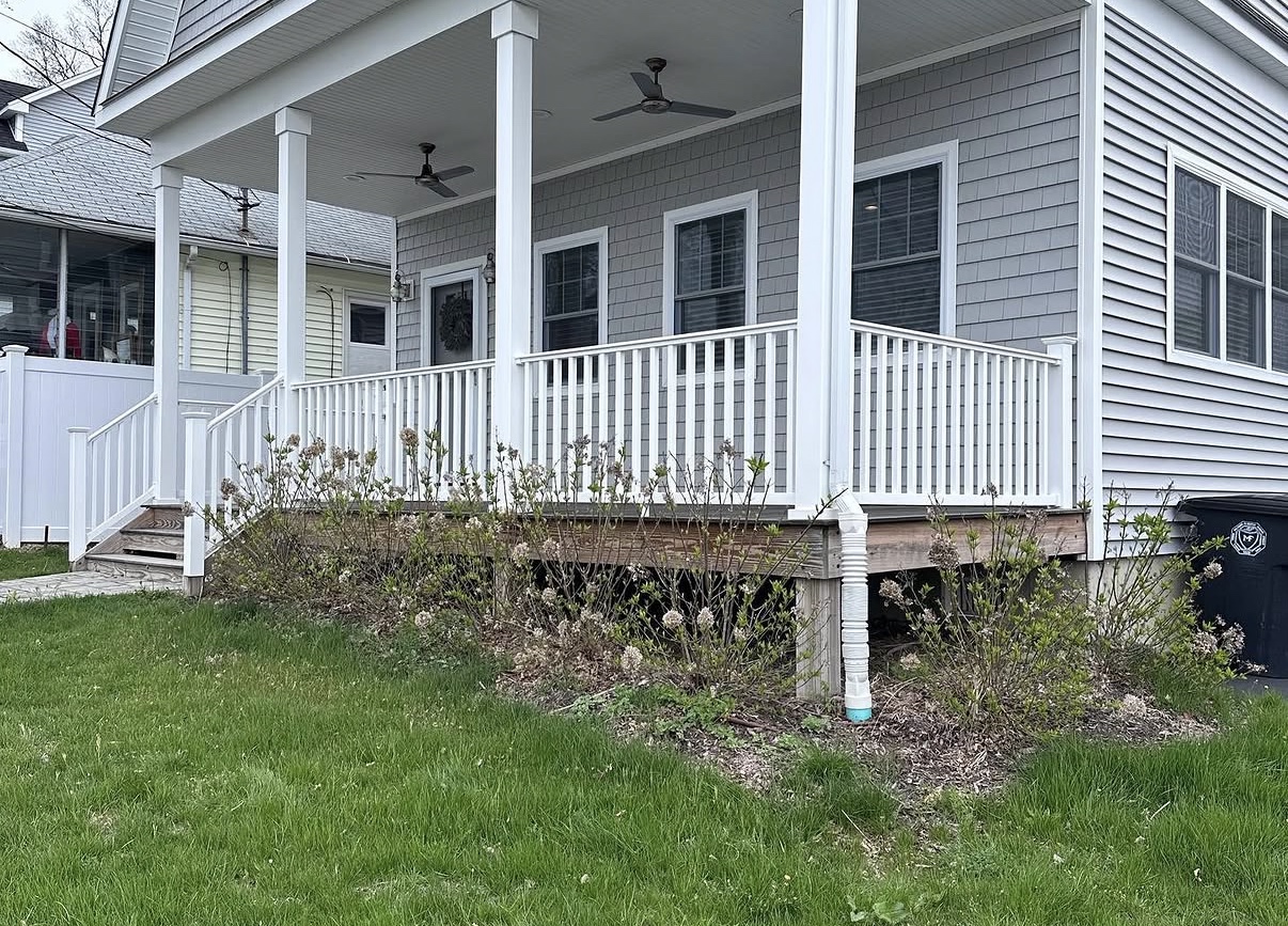 Lawn before Premier Property Maintenance service — overgrown grass and tired beds