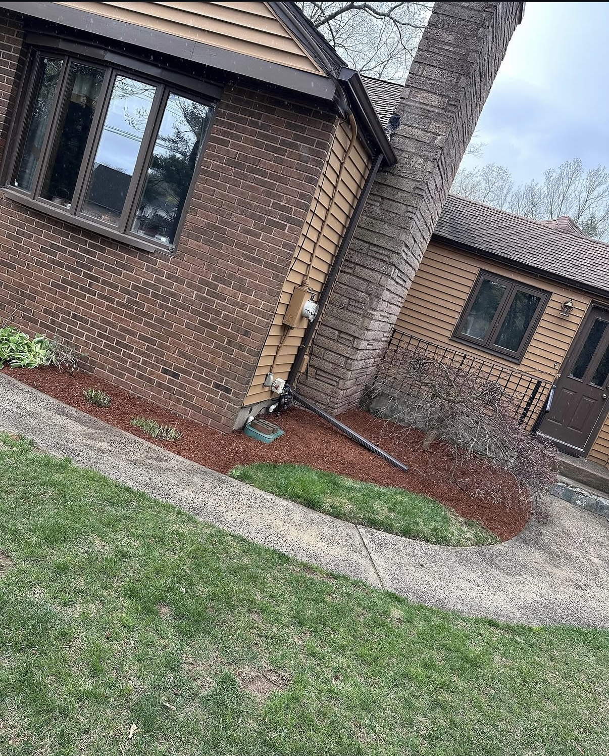 Garden bed after fresh mulch, new plantings, and crisp edging